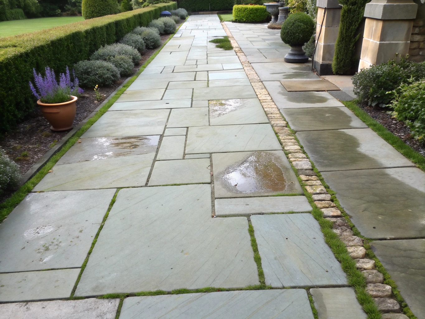 Clean stone paver walkway leading to residential entrance